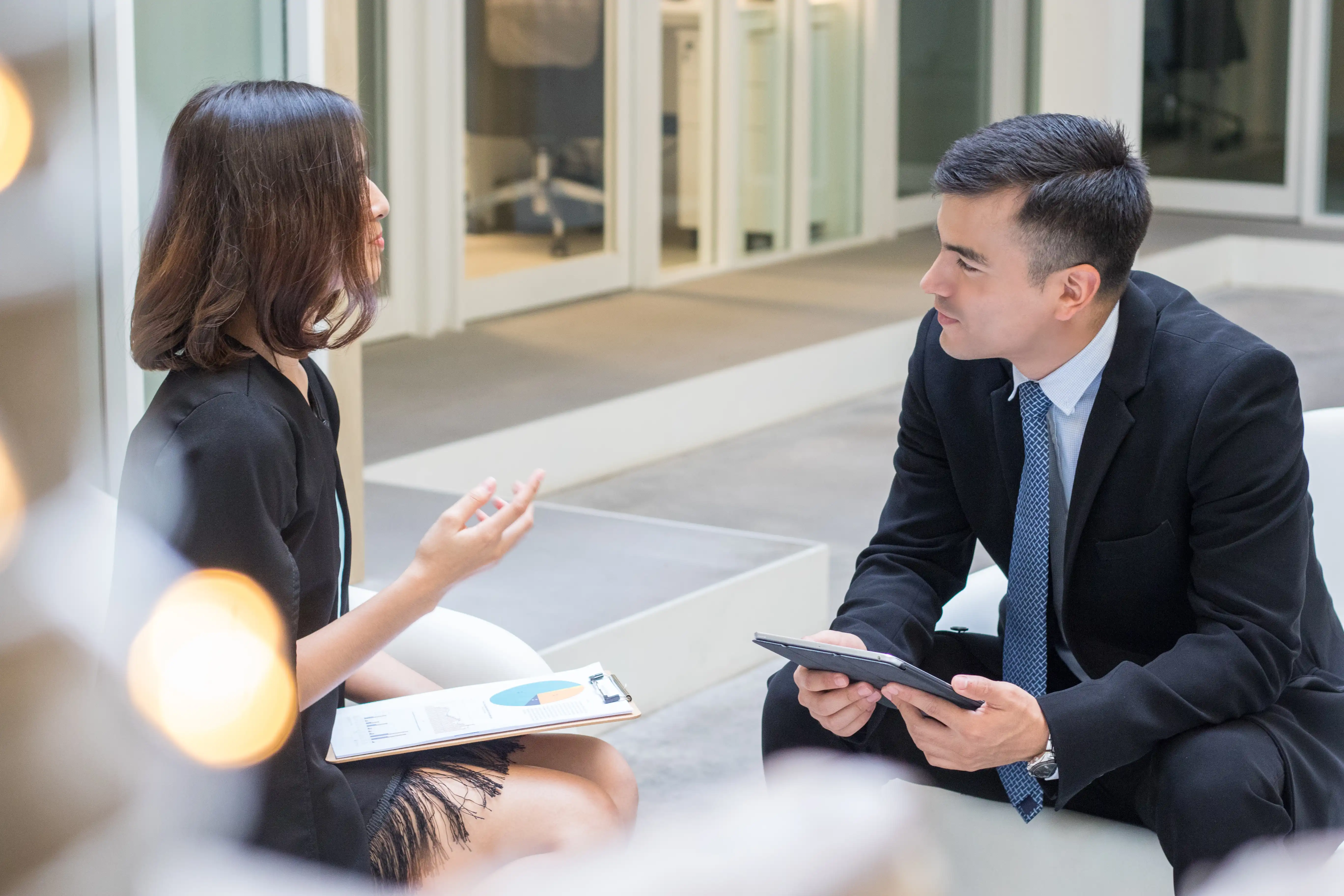 Smiling man on a laptop in a meeting