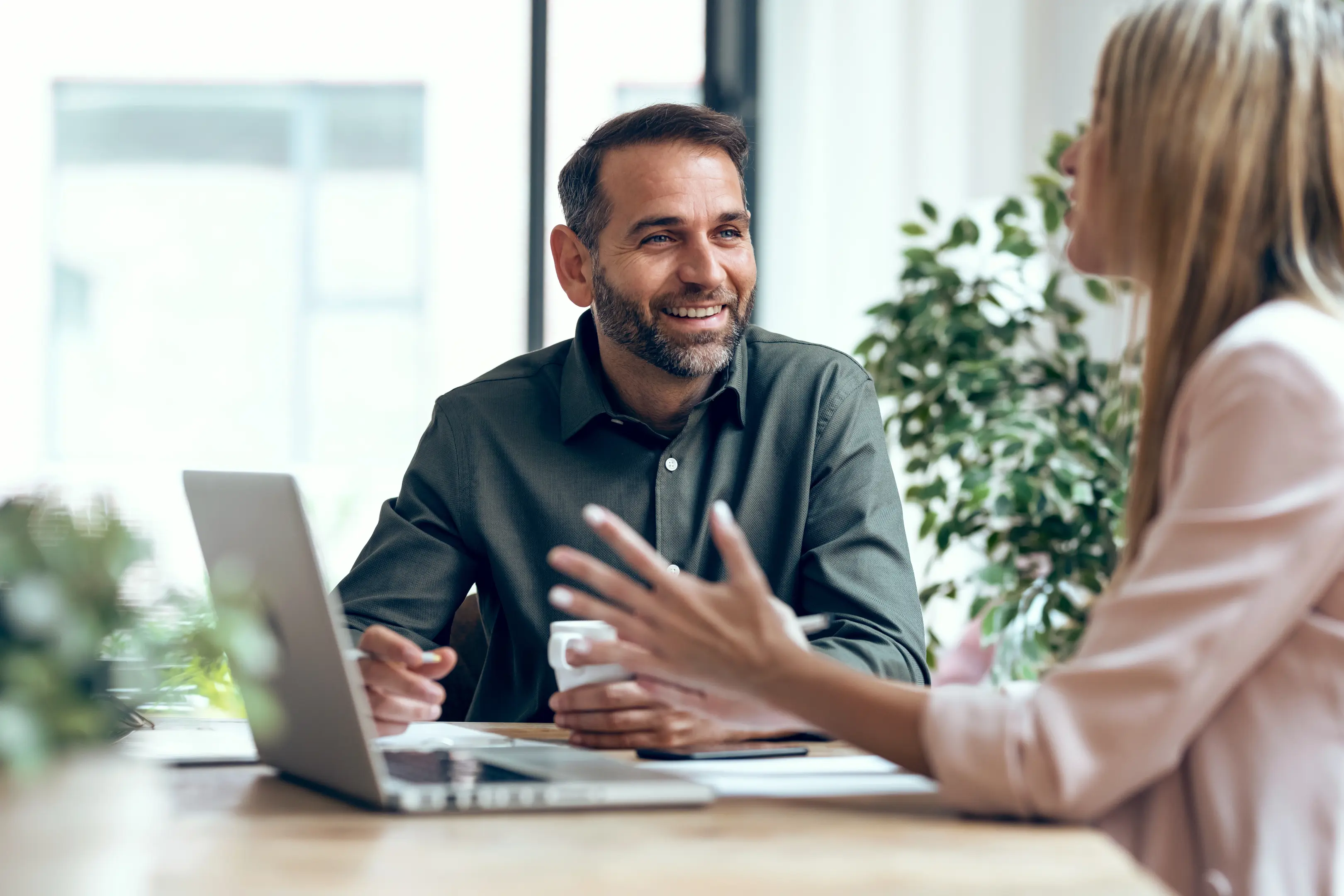 A man happily conversing during a meeting